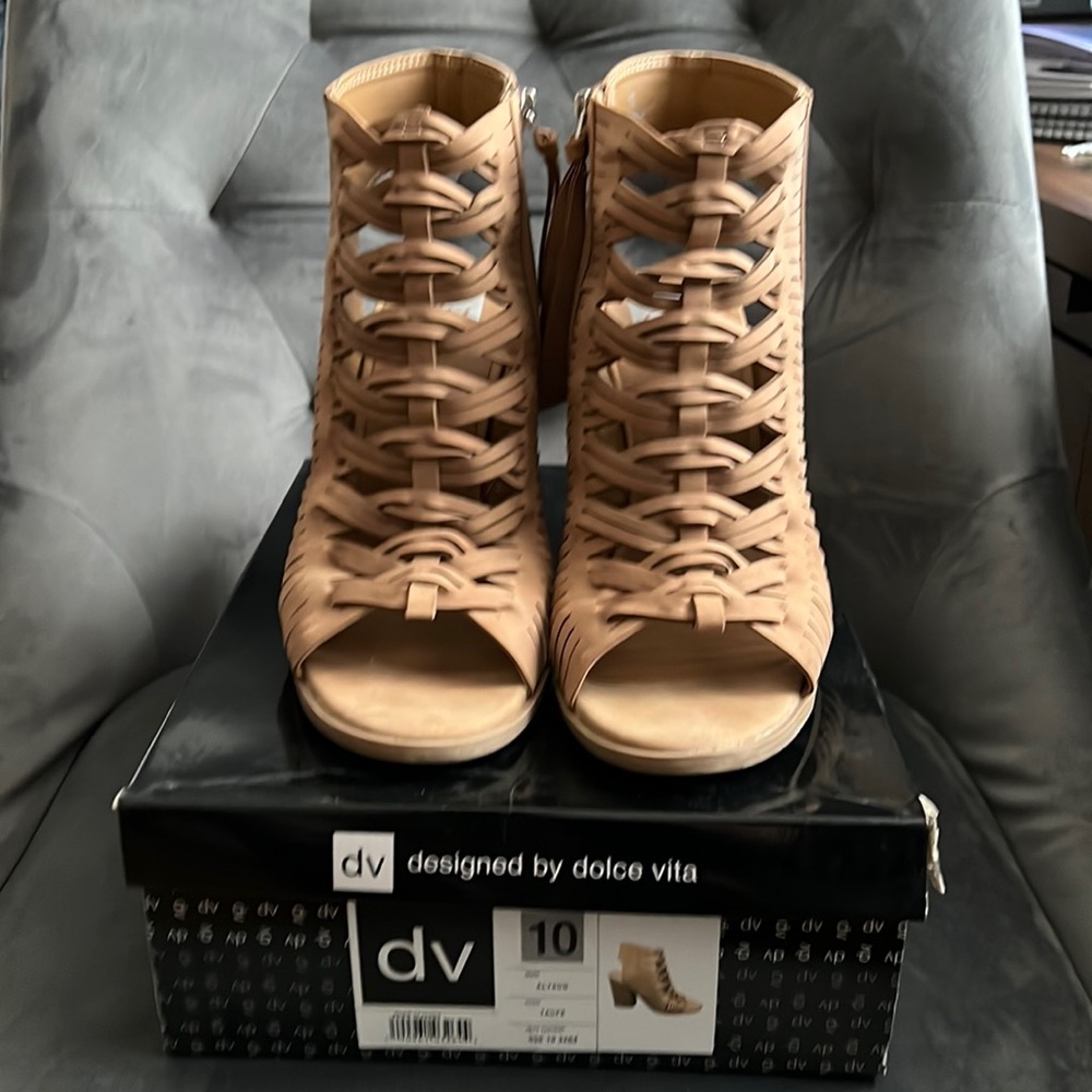 Tan open toe & heel booties with zipper closure.